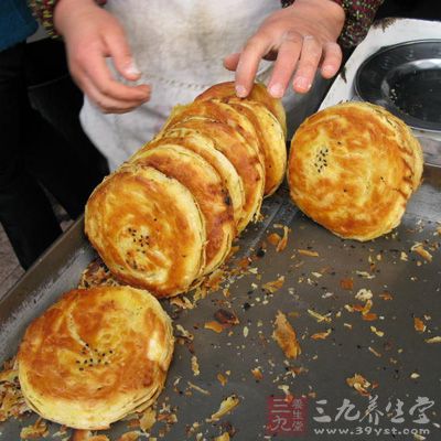 將燒餅生坯均勻地碼入烤盤內,放進烤爐或烤箱中 將燒餅生坯均勻地碼入烤盤內,放進烤爐或烤箱中